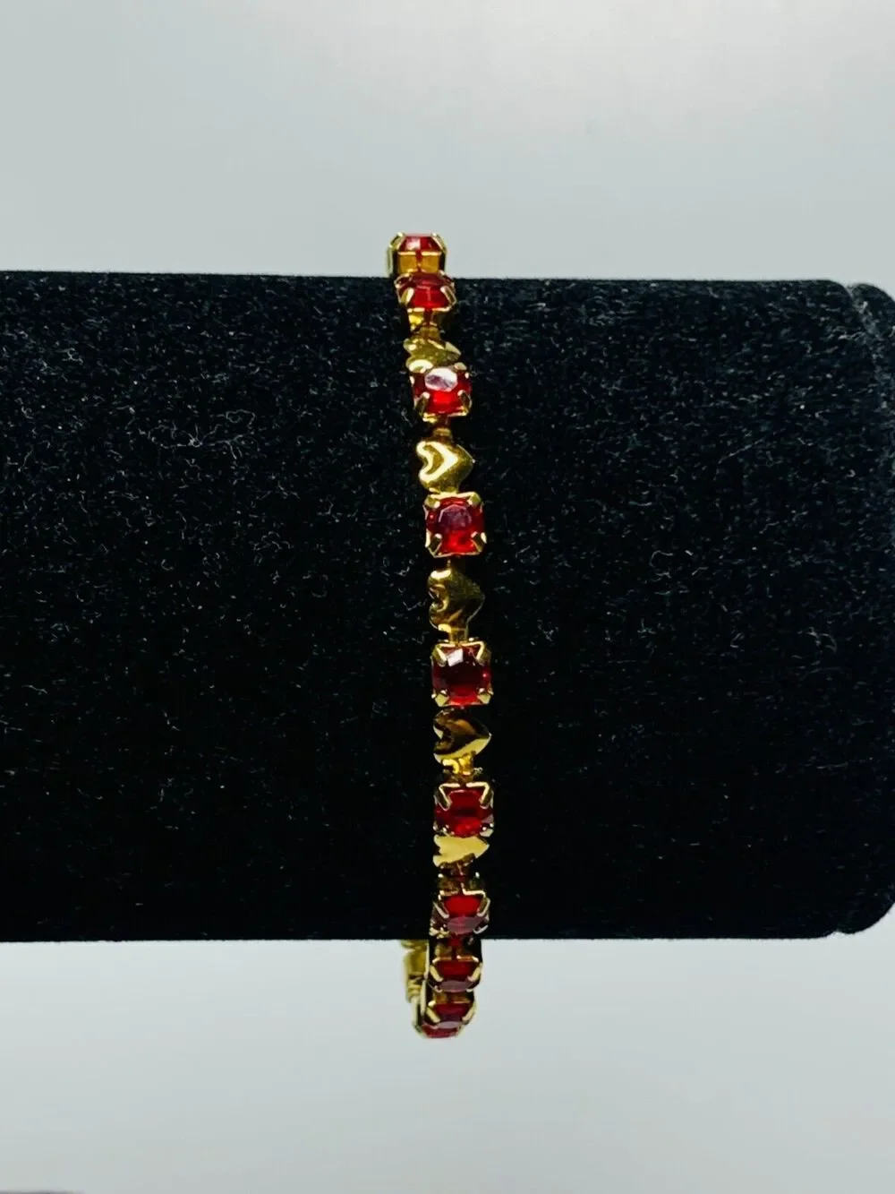 Red Stone Tennis Bracelet with Little Gold Hearts in Between Each Stone